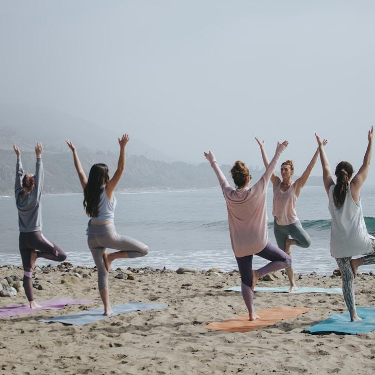 Women in a fitness class doing stretching and mobility exercises